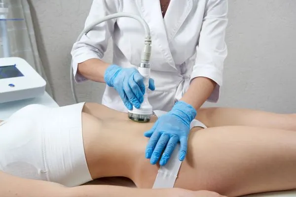 Lost the Weight but Not the Loose Skin? 2 woman having HIFU treatment on her stomach to combat loose skin Swindon following weight loss
